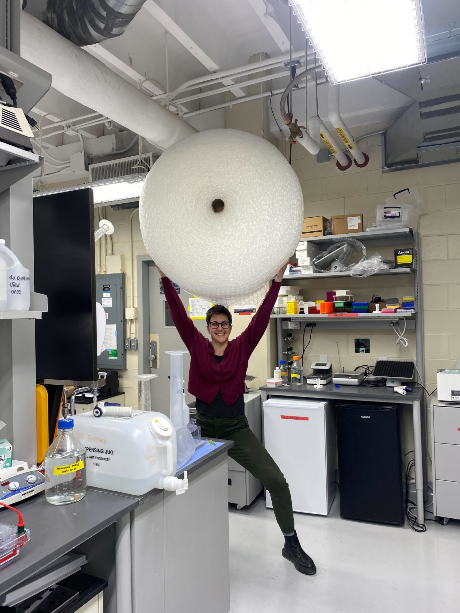 Gilda Stefanelli holding a giant roll of bubble wrap triumphantly